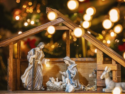 Christmas Manger scene with figurines including Jesus, Mary, Joseph and sheep. Focus on mo