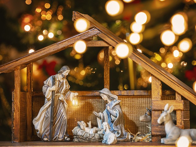 Christmas Manger scene with figurines including Jesus, Mary, Joseph and sheep. Focus on mother!