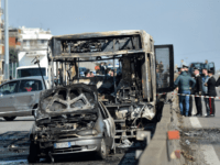TOPSHOT - The wreckage of a school bus that was transporting some 50 children is pictured on March 20, 2019 after it was torched by the bus' driver, in San Donato Milanese, southeast of Milan. - Italian police rescued some 50 children on March 20, 2019 after their driver threatened …