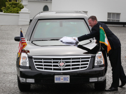 DUBLIN, IRELAND - MAY 23: A secret service agent wipes rainwater from US President Barack Obama's limousine at Áras an Uachtaráin on May 23, 2011 in Dublin, Ireland. U.S. President Obama is visiting Ireland for one day. He will meet with distant relatives in Moneygall and speak at a rally …