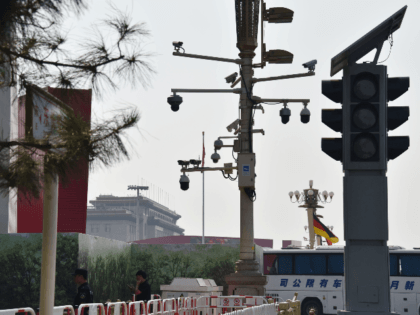 Security guards patrol below surveillance cameras on a corner of Tiananmen Square in Beijing on September 6, 2019. - Some Beijing karaoke bars are closing, toy bombs are banned and every delivery package is being scanned: the capital is taking no chances weeks ahead of a massive military parade to …