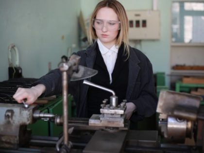 Young woman engineer working at machine tool manufacturing