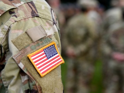American Soldiers and Flag of USA on soldiers arm. US Army. Veteran Day