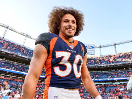 Phillip Lindsay #30 of the Denver Broncos smiles as he walks on the field after the Denver Broncos 16-0 win over the Tennessee Titans at Empower Field at Mile High on October 13, 2019 in Denver, Colorado. (Photo by Dustin Bradford/Getty Images)