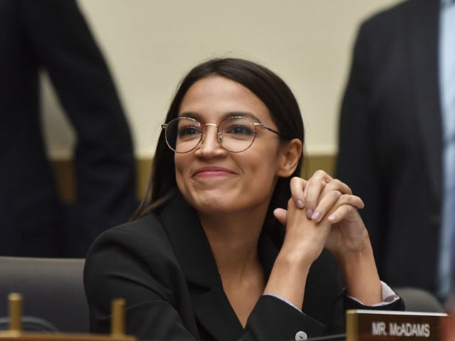 Rep. Alexandria Ocasio-Cortez(D-NY) smiles as Facebook Chairman and CEO Mark Zuckerberg testifies before the House Financial Services Committee on "An Examination of Facebook and Its Impact on the Financial Services and Housing Sectors" in the Rayburn House Office Building in Washington, DC on October 23, 2019. (Photo by Nicholas Kamm …