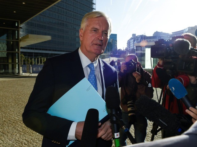 EU chief Brexit negotiator Michel Barnier (C) answers journalists' questions as he ar
