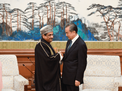 Oman's Ambassador to China, Abdullah Saleh Al Saadi (L), shakes hands with Chinese Foreign Minister Wang Yi before their meeting at the Diaoyutai State Guesthouse in Beijing on October 30, 2019. (Photo by MADOKA IKEGAMI / POOL / AFP) (Photo by MADOKA IKEGAMI/POOL/AFP via Getty Images)