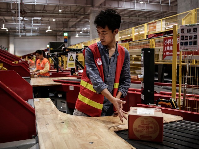 WUHAN, CHINA - NOVEMBER 05: (CHINA OUT)An employee sort out parcels at the JingDong Group on November 5,2019 in Wuhan, Hubei province.China. ahead of the Double 11 Shopping Festival more scientific and technological equipment was applied to the logistics express production line.China Post website said that 2019 Double 11 Shopping …