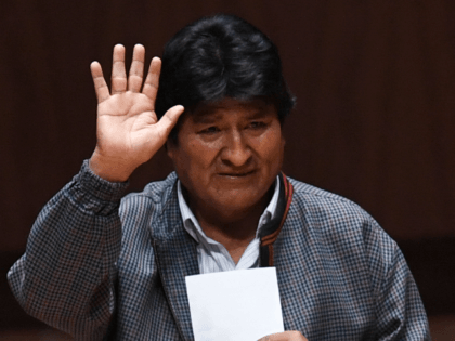 Bolivia's ex-President Evo Morales waves upon his arrival at the Ollin Yoliztli cultural c