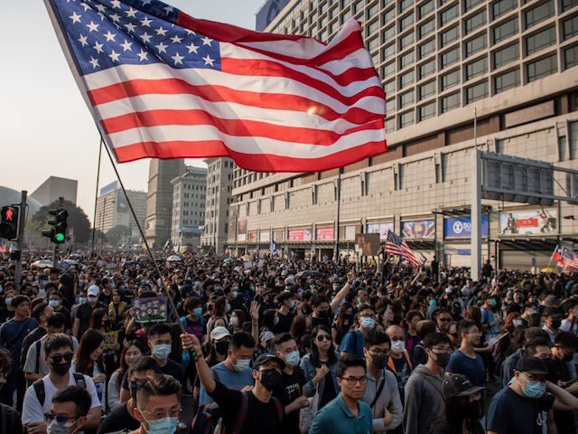 People take part in a march from the Tsim Sha Tsui district to Hung Hom in Hong Kong on De