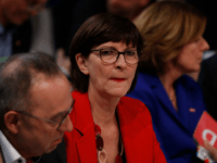 Newly elected Germany's social democratic SPD party co-leader Saskia Esken (C) looks on next to newly elected co-leader Norbert Walter-Borjans (L) during the party congress of Germany's Social Democrats (SPD) at the fairgrounds in Berlin, on December 6, 2019. - The new, leftist leaders of Germany's Social Democrats offered Angela …