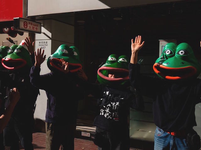 People wearing masks depicting Pepe the Frog, a character used by pro-democracy activists as a symbol of their struggle, gather before the 'Human Rights Day' rally from Victoria Park to Chater Road in Hong Kong on December 8, 2019. - Hong Kong democracy protesters are hoping for huge crowds December 8 at a rally they have billed as a "last chance" for the city's pro-Beijing leaders in a major test for the six-month-old movement. (Photo by Alastair Pike / AFP) (Photo by ALASTAIR PIKE/AFP via Getty Images)