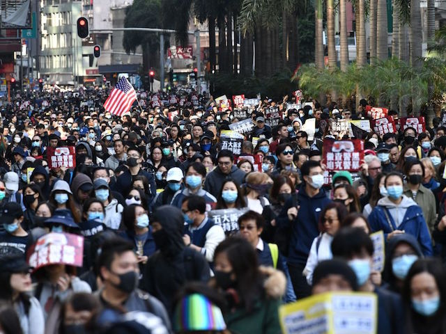 People take part in a pro-democracy rally from Victoria Park to Chater Road in Hong Kong on December 8, 2019. - Vast crowds of democracy protesters thronged Hong Kong's streets on December 8 in a forceful display of support for the movement on its six-month anniversary, as organisers warned the city's pro-Beijing leaders they had a "last chance" to end the political crisis. (Photo by Anthony WALLACE / AFP) (Photo by ANTHONY WALLACE/AFP via Getty Images)
