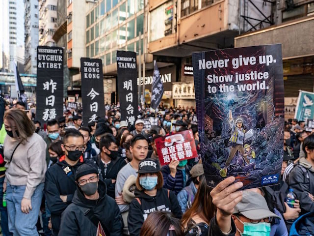 HONG KONG, CHINA - DECEMBER 8: Pro-democracy protesters march on a street as they take par