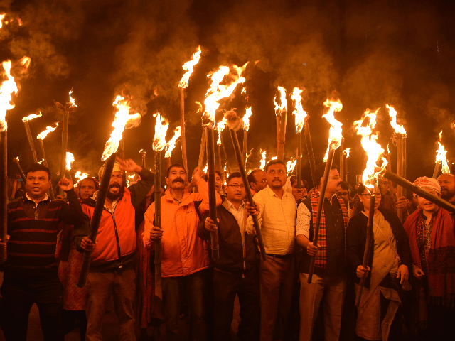 Krishak Mukti Sangram Samiti (KMSS) activists take part in a torch light procession to protest against the government's Citizenship Amendment Bill, in Guwahati on December 9, 2019. - India's parliament saw raucous scenes on December 9 and protests raged in the north-east of the country as MPs debated legislation that stands to give citizenship to religious minorities from neighbouring countries, but not Muslims. To Muslim organisations, rights groups and others, the bill forms part of Prime Minister Narendra Modi's agenda -- which he denies -- of marginalising India's 200-million-strong Islamic minority. (Photo by Biju BORO / AFP) (Photo by BIJU BORO/AFP via Getty Images)