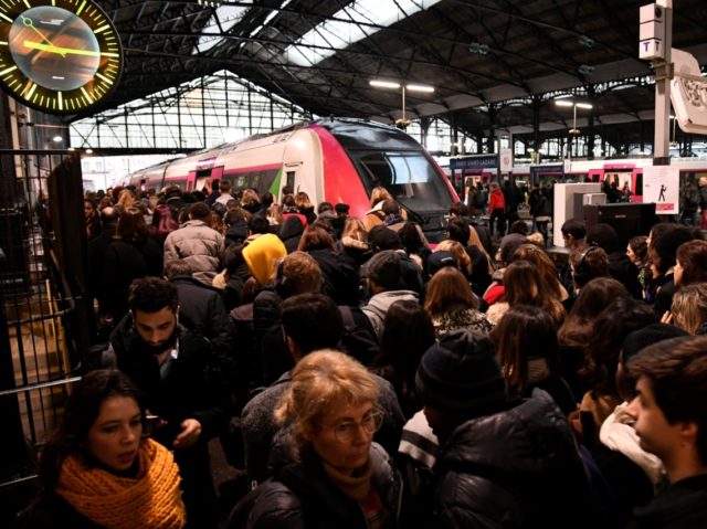 Commuters are seen at the Gare Saint-Lazare train station in Paris, on December 16, 2019,