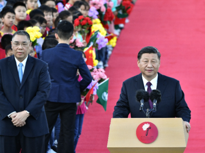 China's President Xi Jinping (R), with Macau's outgoing Chief Executive Fernando Chui (L), speaks upon his arrival at Macau's international airport in Macau on December 18, 2019, ahead of celebrations for the 20th anniversary of the handover from Portugal to China. - Chinese president Xi Jinping landed in Macau on …