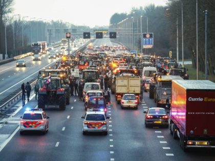Dutch farmers use tractors to blockade the A9 Highway at Uitgeest, north of Amsterdam on December 18, 2019, as they protest a clampdown on nitrogen emissions that they claim could wreak havoc on their businesses. (Photo by Koen Van WEEL / ANP / AFP) / Netherlands OUT (Photo by KOEN …