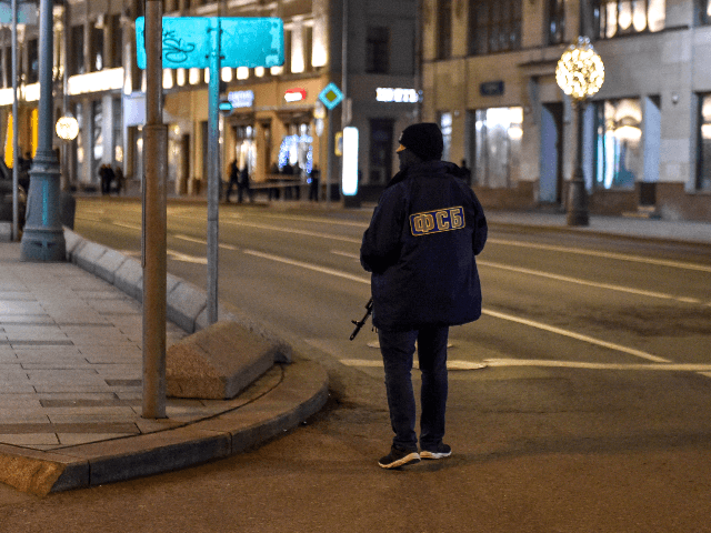 Russian Federal Security Service officer patrols a street next to the FSB security service