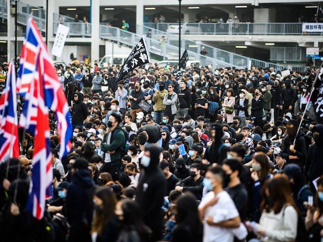 People attend a rally in Hong Kong on December 22, 2019 to show support for the Uighur minority in China. - Hong Kong riot police broke up a solidarity rally for China's Uighurs on December 22 -- with one officer drawing a pistol -- as the city's pro-democracy movement likened …