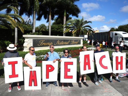 DORAL, FL - DECEMBER 17: Protesters gather outside of the Trump National Doral golf resort urging congress to impeach President Donald Trump on December 17, 2019 in Doral, Florida. The protest is one of many being held across the country calling for President Donald Trump's removal from office on the …