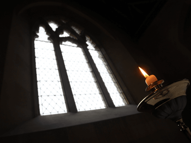 IMBER, ENGLAND - DECEMBER 31: Candles are lit ahead of the 10th New Year's Eve peace vigil being held inside the 700-year-old St Giles church in the village of Imber on December 31, 2011 on Salisbury Plain, England. The church along with the rest of the village was evacuated in …