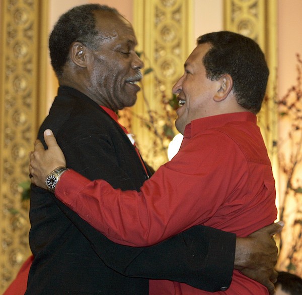 Venezuelan President Hugo Chavez(R) and actor/activist Danny Glover hug while attending the The CITGO-Venezuela Heating Oil Program innauguration ceremony at the Mt. Olivet Baptist Church in Harlem 21 September. Chavez addressed the United Nations General Assembly 20 September. AFP PHOTO / Timothy A. CLARY (Photo credit should read TIMOTHY A. CLARY/AFP via Getty Images)