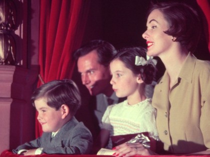 A family watching a Christmas show from a theatre box. (Photo by Housewife/Getty Images)