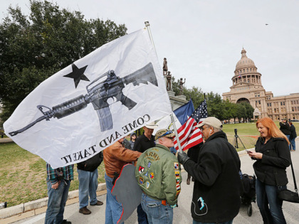 AUSTIN, TX - JANUARY 1: On January 1, 2016, the open carry law took effect in Texas, and 2nd Amendment activists held an open carry rally at the Texas state capitol on January 1, 2016 in Austin, Texas. Armando Valledares of Killeen holds the "Come And Take It" flag. (Photo …