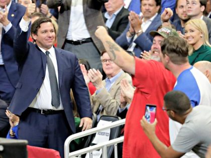 Ron DeSsntis and supporters after he was introduced at a rally where President Donald Trump formally announced his 2020 re-election bid Tuesday, June 18, 2019, in Orlando, Fla. (AP Photo/John Raoux)