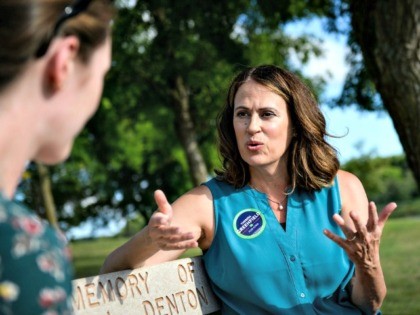 Democratic Senate candidate Theresa Greenfield speaks with a reporter at a picnic hosted b