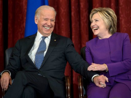 Former US Secretary of State, Hillary Clinton shares a laugh with US Vice President Joseph Biden, during a portrait unveiling ceremony for outgoing Senate Minority Leader Harry Reid (D-NV), on Capitol Hill December 8, 2016 in Washington, DC. (Photo by Mark Wilson/Getty Images)