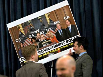 WASHINGTON, DC - DECEMBER 11: House Judiciary Committee staff members remove the signs after finishing the House Judiciary Committee markup of the articles of impeachment against President Donald Trump, December 11, 2019 in Washington, DC. The articles of impeachment charge Trump with abuse of power and obstruction of Congress. House …