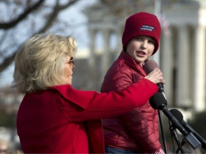 Actress and activist Jane Fonda holds the microphone for Iain Armitage an 11-year-old acto