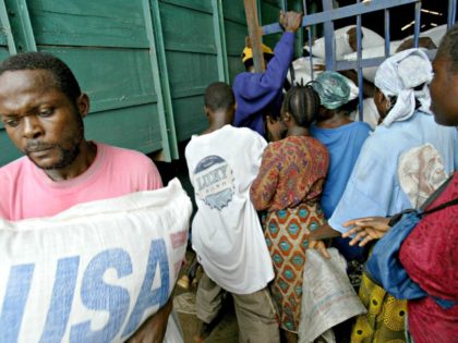MONROVIA, LIBERIA - AUGUST 13: Hungry Liberians try to force their way into a warehouse fu