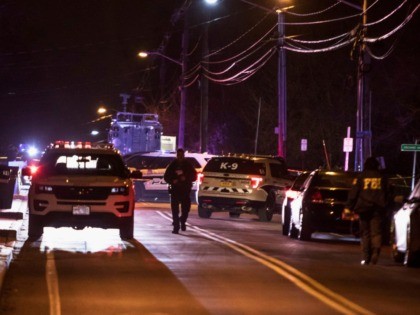Authorities gather on a street in Monsey, N.Y., Sunday, Dec. 29, 2019, following a stabbing late Saturday during a Hanukkah celebration. A man attacked the celebration at a rabbi's home north of New York City late Saturday, stabbing and wounding several people before fleeing in a vehicle, police said. (AP …