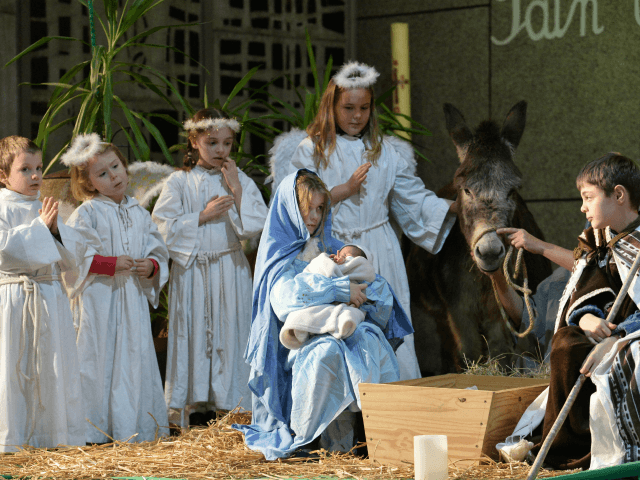 Children perform a nativity scene on Christmas Eve at the Saint-Liboire Church in Le Mans, western France, on December 24, 2017. / AFP PHOTO / JEAN-FRANCOIS MONIER (Photo credit should read JEAN-FRANCOIS MONIER/AFP via Getty Images)