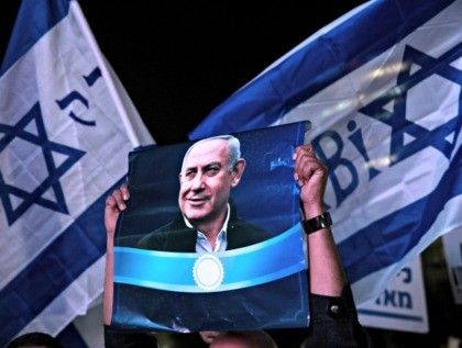 TEL AVIV, ISRAEL - NOVEMBER 26: Supporters hold up banners as thousands of people attend a rally against the Netanyahu indictment on November 26, 2019 in Tel Aviv, Israel. Israel’s attorney general has indicted Benjamin Netanyahu for bribery, fraud and breach of trust. (Photo by Amir Levy/Getty Images)