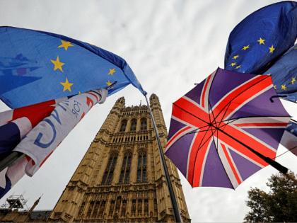 EU flag and Union flag-themed umbrellas of Brexit activists fly outside the Houses of Parliament in London on October 23, 2019. - British Prime Minister Boris Johnson could pivot towards a general election as the EU mulls granting a Brexit deadline extension on Wednesday, after a fresh twist to the …