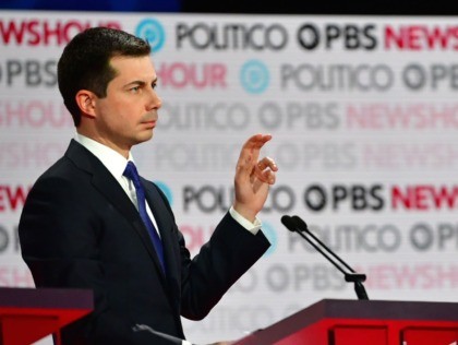 Pete Buttigieg raises his hand (Frederic J. Brown / AFP / Getty)