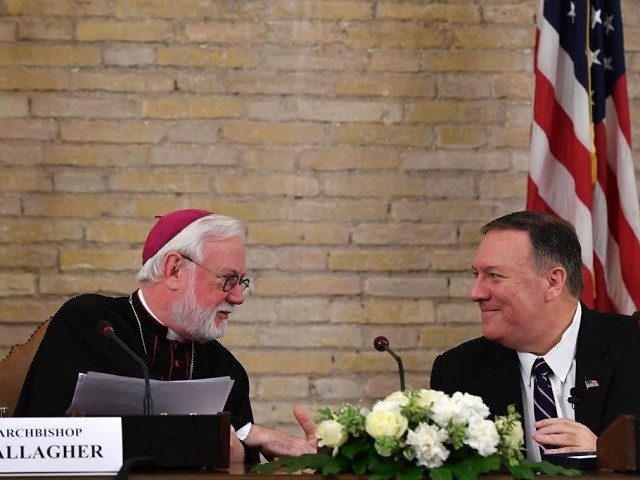 Holy See Secretary for Relations with States, Archbishop Paul Gallagher (L) and US Secretary of State Mike Pompeo shale hands during the launch of a Vatican - US Symposium on Faith-Based Organizations (FBOs), on October 2, 2019 at the Old Synod Hall in the Vatican, as part of Pompeo's four-nation …