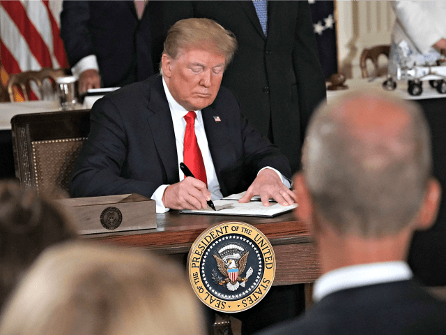 WASHINGTON, DC - JUNE 18: U.S. President Donald Trump signs an executive order during a me