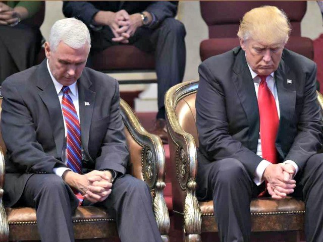 Republican presidential nominee Donald Trump (R) and running mate Mike Pence bow their heads in prayer during the Midwest Vision and Values Pastors and Leadership Conference at the New Spirit Revival Center in Cleveland Heights, Ohio on September 21, 2016.