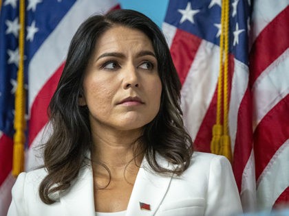 Democratic presidential candidate U.S. Rep. Tulsi Gabbard, D-Hawaii, listens as family members of victims of the terrorist attacks on 9/11 speak during a news conference at the 9/11 Tribute Museum, Tuesday, Oct. 29, 2019, in New York. (AP Photo/Mary Altaffer)