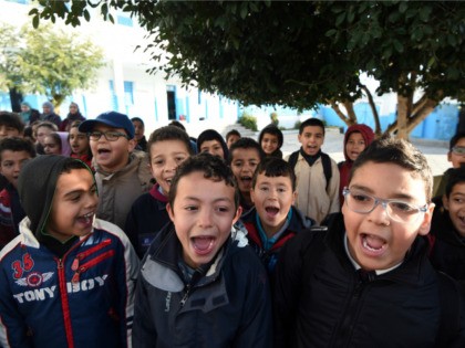 Tunisian schoolchildren sing their national anthem in a primary school in the Tunis suburb of Ariana on March 9, 2016 after having observed a minute of silence for the victims of attacks blamed on the Islamic State group that left dozens dead. Tunisian forces repelled a jihadist assault on a …