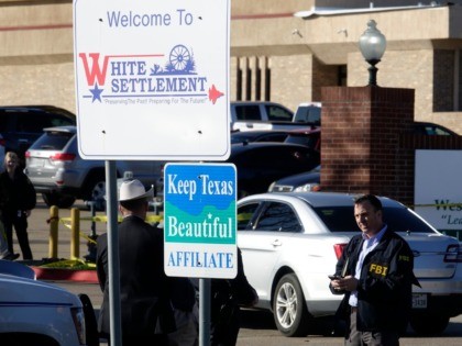 An FBI agent stands outside West Freeway Church of Christ as authorities continue to investigate a fatal shooting at the church, Sunday, Dec. 29, 2019, in White Settlement, Texas. (AP Photo/David Kent)