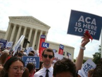 WASHINGTON, DC - JUNE 25: People celebrate in front of the US Supreme Court after ruling was announced on the Affordable Care Act. June 25, 2015 in Washington, DC. The high court ruled that the Affordable Care Act may provide nationwide tax subsidies to help poor and middle-class people buy …