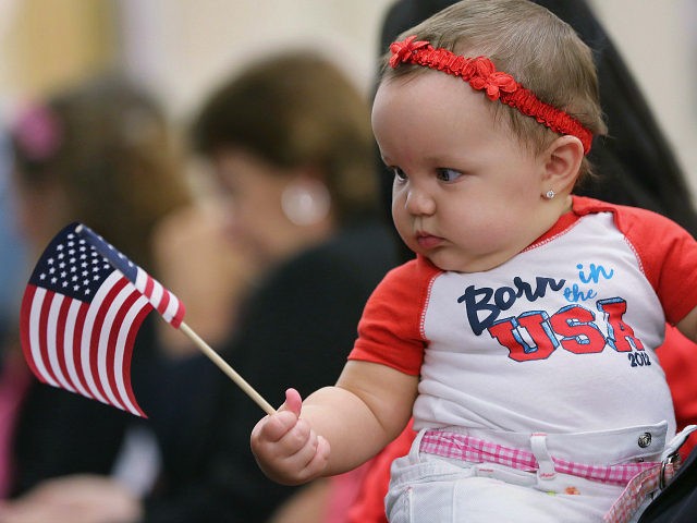 TAMPA, FL - FEBRUARY 14: Cuban immigrant Ed Lacosta holds his baby Melody Grace, 6 months, while sitting with his wife Judy Lacosta at a special Valentine's Day naturalization ceremony for married couples on February 14, 2013 in Tampa, Florida. The U.S. Citizenship and Immigration Service (USCIS) held the Valentine's …
