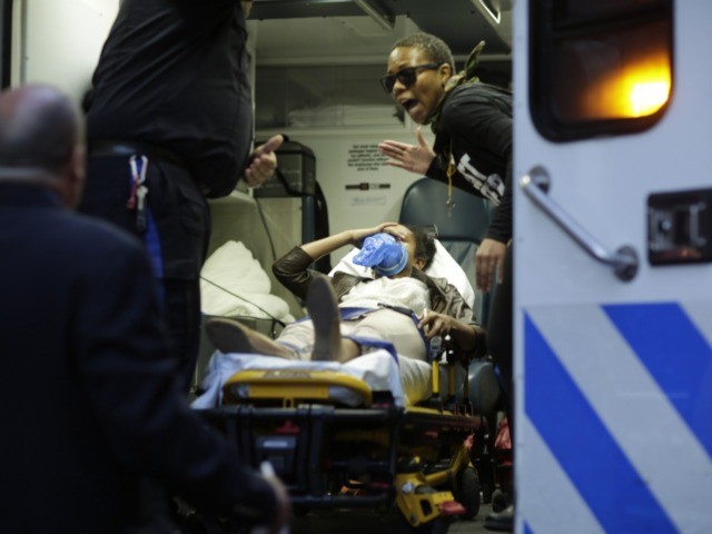 A protester is seen inside of an ambulance after being arrested during a rally on April 29