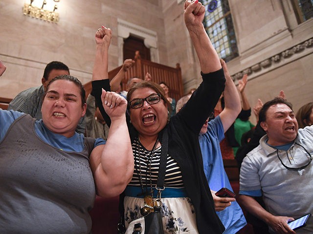 Spectators celebrate after legislation sponsoring the Green Light Bill granting undocumented Immigrant driver's licenses was passed by the Senate during a Senate session at the state Capitol Monday, June 17, 2019, in Albany, N.Y. (AP Photo/Hans Pennink)